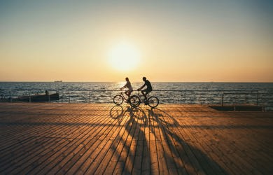 couple cycling on the pier 