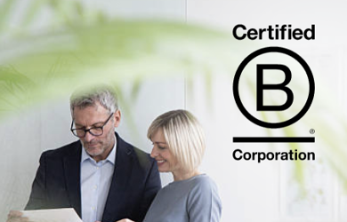 Colleagues talking with B Corp logo