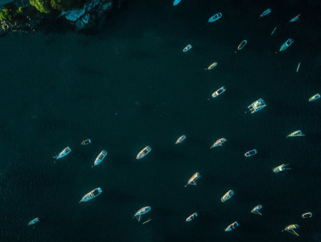 Yachts Sailing Across Calm, Open Waters Under A Clear Sky